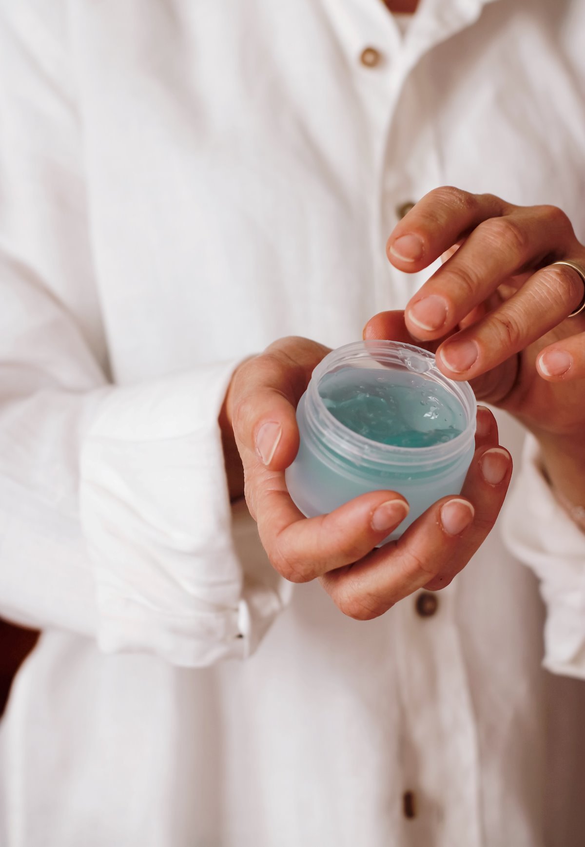 Close-up Of Person Using Beauty Product Plastic