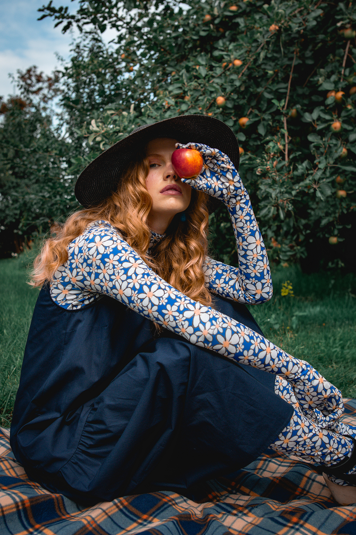 Model Holding An Apple In Front Of Her Eye
